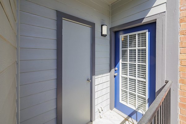 Cozy outdoor patio with seating and lush greenery at Clear Creek Meadows Apartments