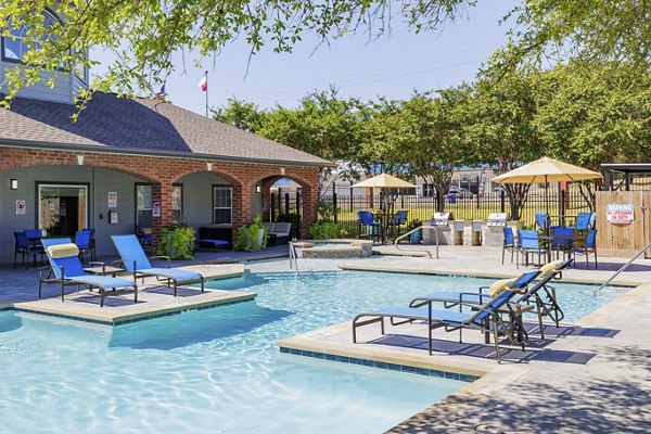 Resort-style pool surrounded by lush greenery at Clear Creek Meadows Apartments