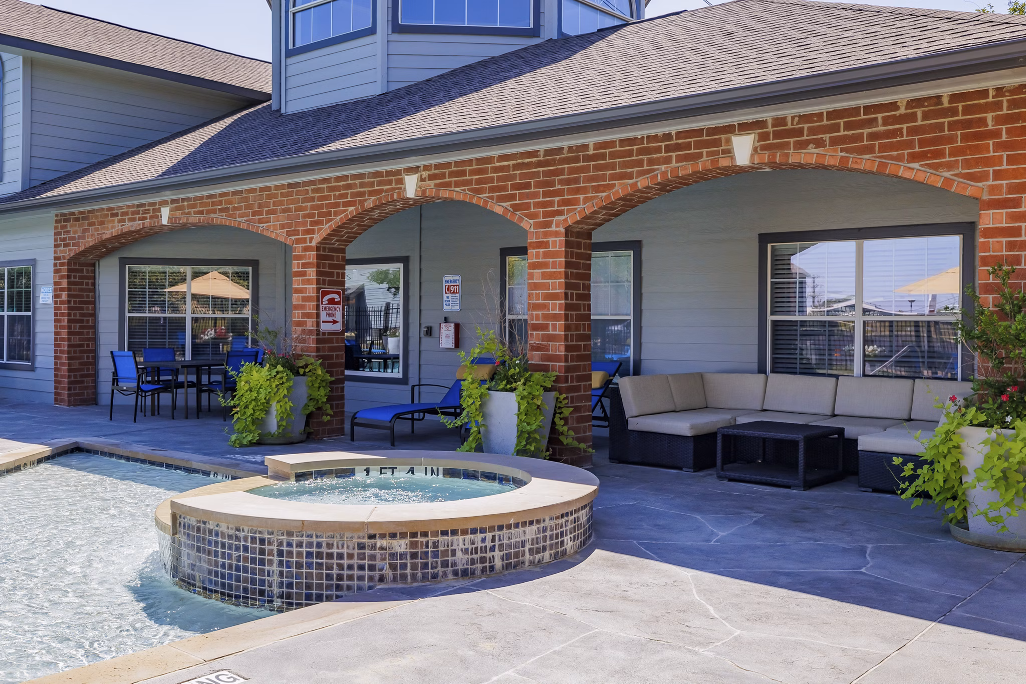 Resort-style pool with lush landscaping at Clear Creek Meadows Apartments