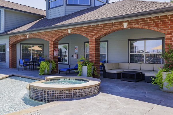Resort-style pool with lush landscaping at Clear Creek Meadows Apartments