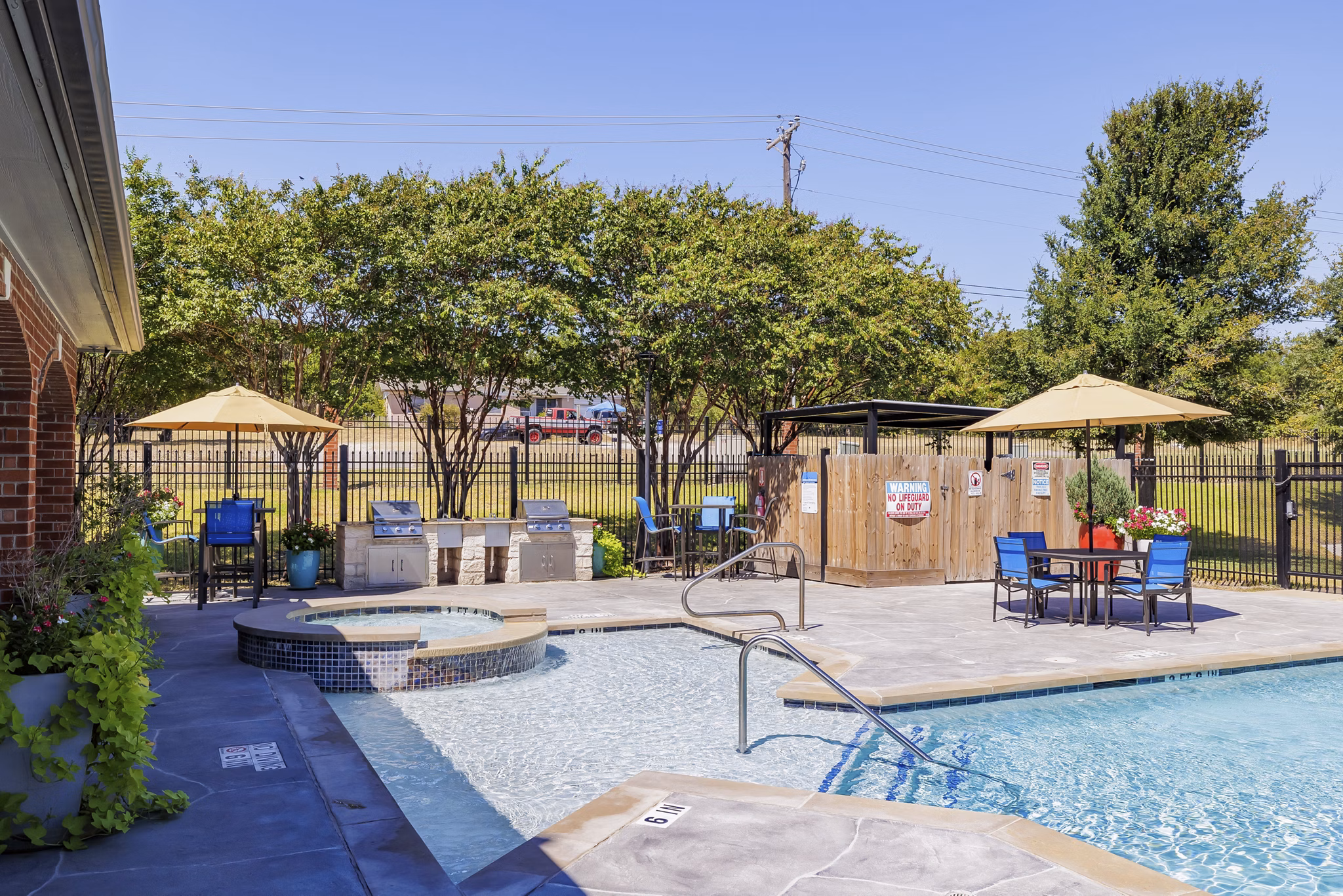 Resort-style swimming pool with sun loungers at Clear Creek Meadows Apartments, perfect for relaxation and social gatherings