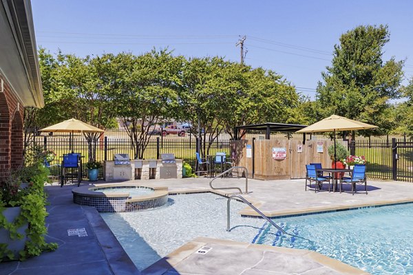 Resort-style swimming pool with sun loungers at Clear Creek Meadows Apartments, perfect for relaxation and social gatherings