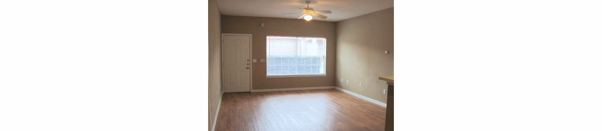 Spacious living room with modern decor at Braunfels Place Apartments, showcasing elegant luxury features in a prime location