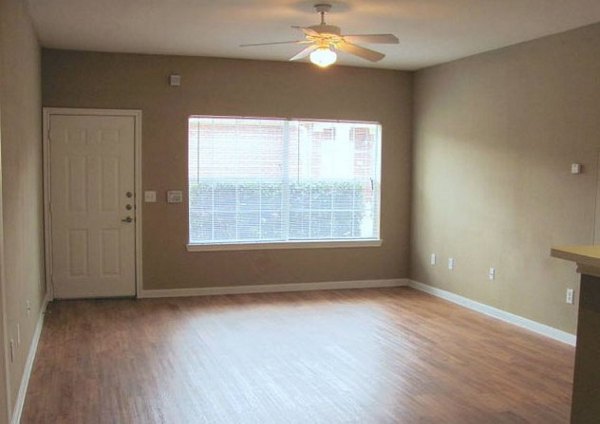 Spacious living room with modern decor at Braunfels Place Apartments, showcasing elegant luxury features in a prime location