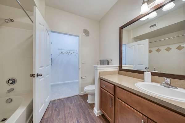 Modern bathroom with sleek fixtures at South Bay Apartments, featuring luxury design and ample storage space