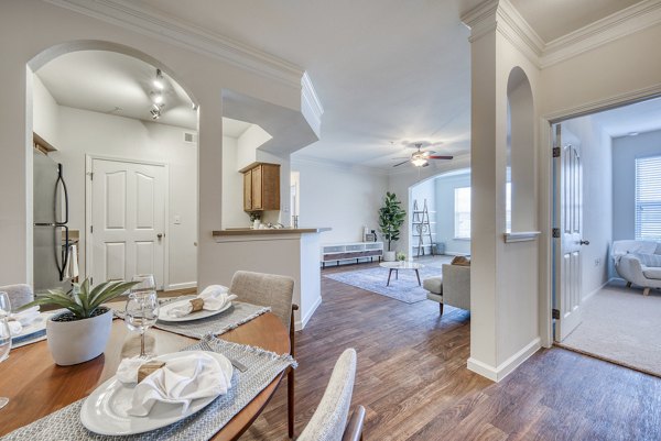 Dining area with modern furnishings in South Bay Apartments, featuring elegant lighting and chic decor