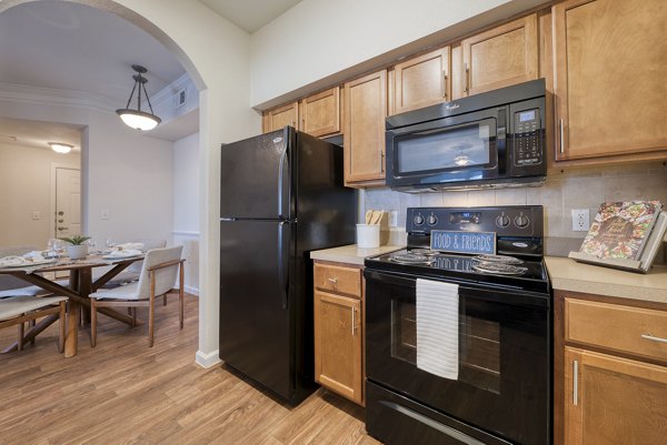 Kitchen featuring stainless steel appliances and granite countertops at South Bay Apartments