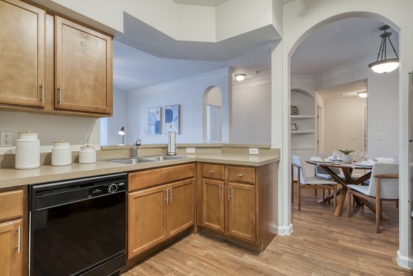 Modern kitchen featuring stainless steel appliances at South Bay Apartments, luxury living with elegant finishes and open layout