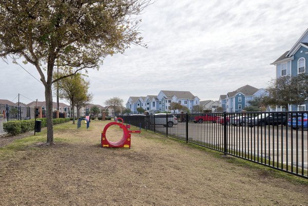 Dog park featuring agility equipment at South Bay Apartments, a pet-friendly Greystar community in Southern California