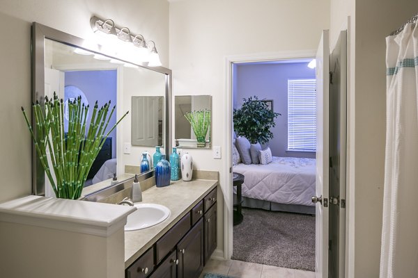 Luxury bathroom with sleek slate tiles and modern fixtures at Avana Sugar Land Apartments
