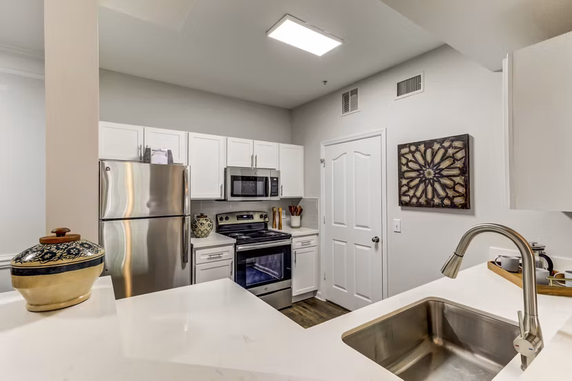 Modern kitchen with stainless steel appliances in Avana Sugar Land Apartments