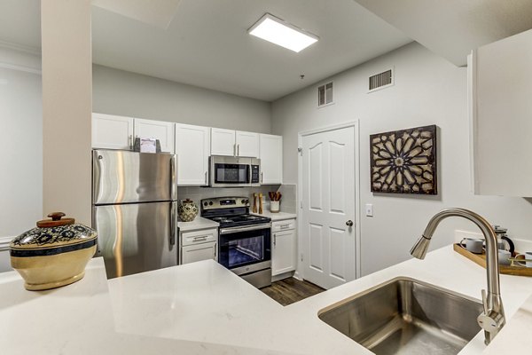 Modern kitchen with stainless steel appliances in Avana Sugar Land Apartments