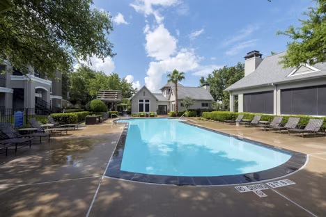 Relaxing pool with lounge area at West End Apartments, luxurious community offering modern amenities and recreational spaces