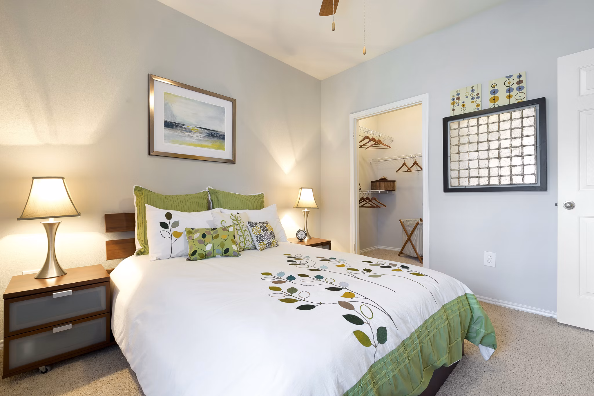 Cozy bedroom with modern decor and ample natural light at Terrazzo Apartments