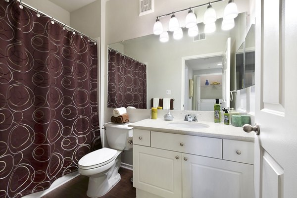 Modern bathroom with marble countertops and sleek fixtures at Terrazzo Apartments, offering luxurious amenities in a stylish setting