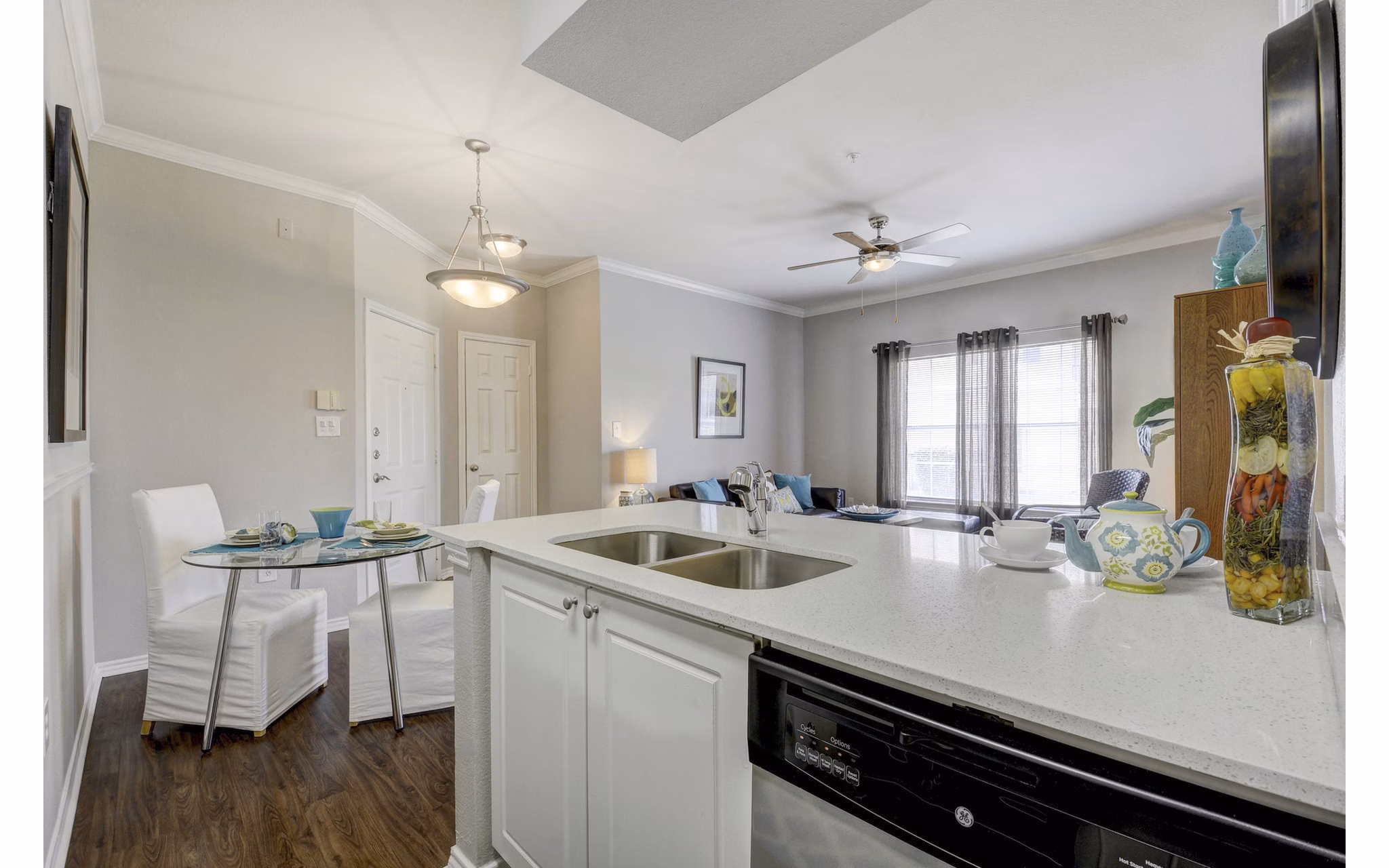 Modern kitchen with stainless steel appliances at Terrazzo Apartments featuring sleek cabinetry and granite countertops