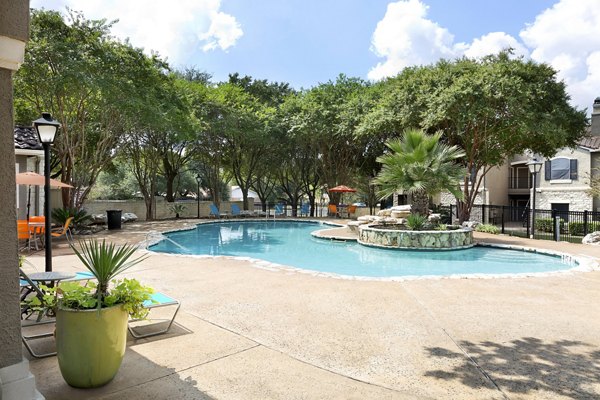 Resort-style swimming pool with lounge seating at Terrazzo Apartments, luxury living in a vibrant community