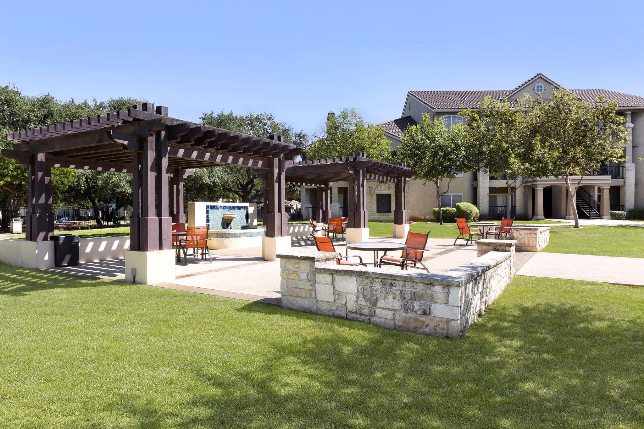 Chic outdoor patio with modern seating at Terrazzo Apartments, perfect for relaxation and social gatherings