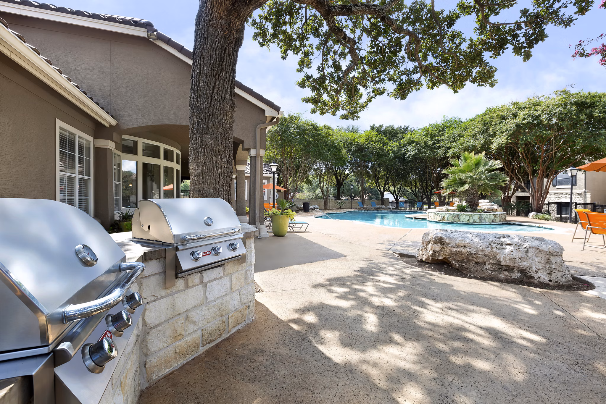 Outdoor grilling area with modern facilities at Terrazzo Apartments, perfect for social gatherings and entertaining