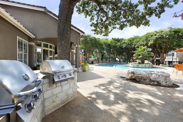 Outdoor grilling area with modern facilities at Terrazzo Apartments, perfect for social gatherings and entertaining