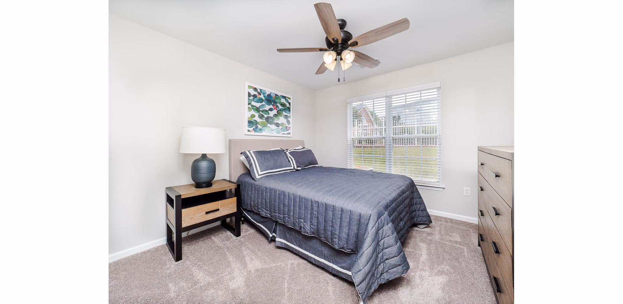 Spacious bedroom with modern decor at Patriots Pointe Apartments, offering luxury living near amenities and attractions