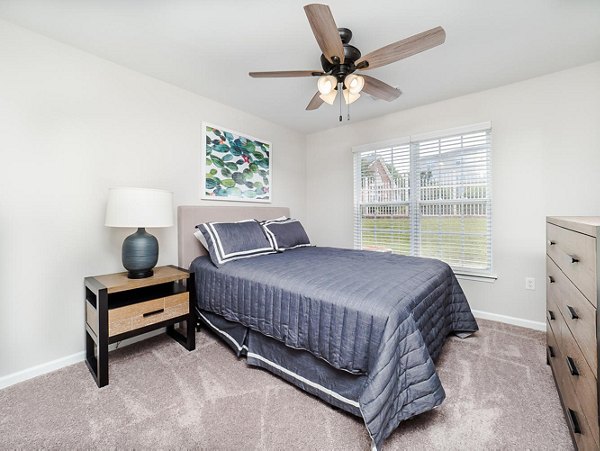 Spacious bedroom with modern decor at Patriots Pointe Apartments, offering luxury living near amenities and attractions