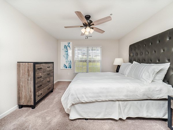Luxe bedroom with contemporary furnishings at Patriots Pointe Apartments