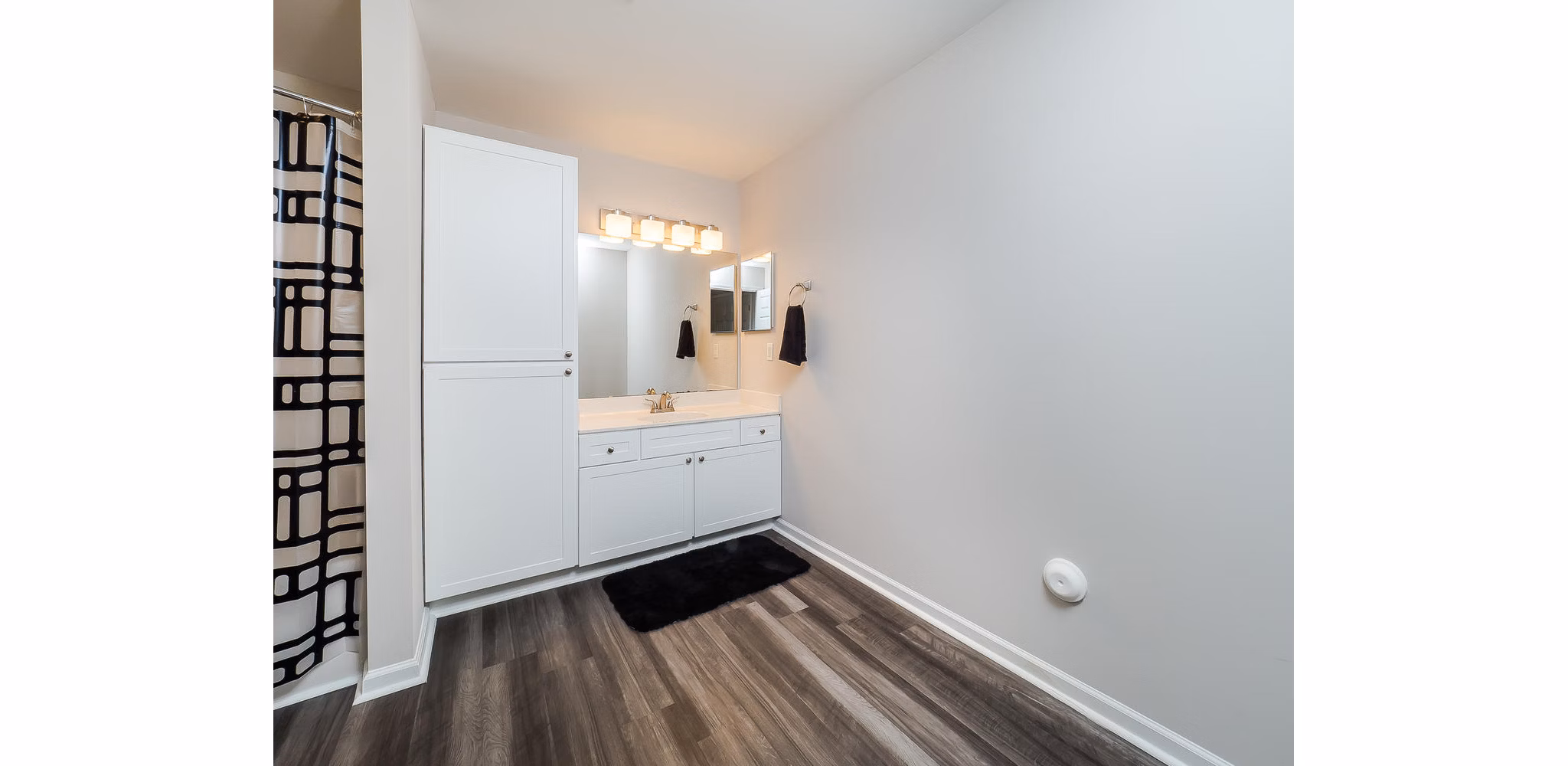 Modern bathroom with sleek fixtures and marble countertop in Patriots Pointe Apartments