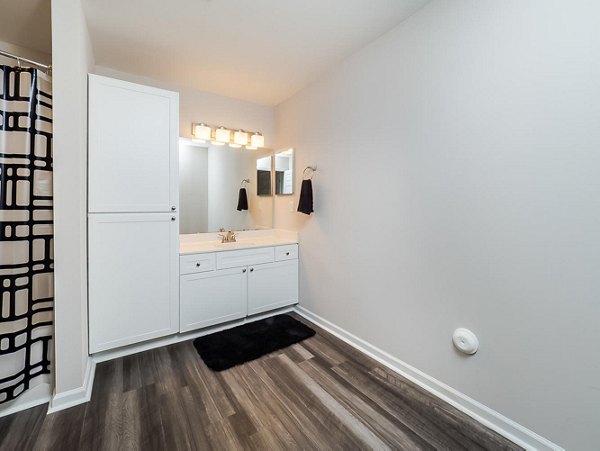 Modern bathroom with sleek fixtures and marble countertop in Patriots Pointe Apartments