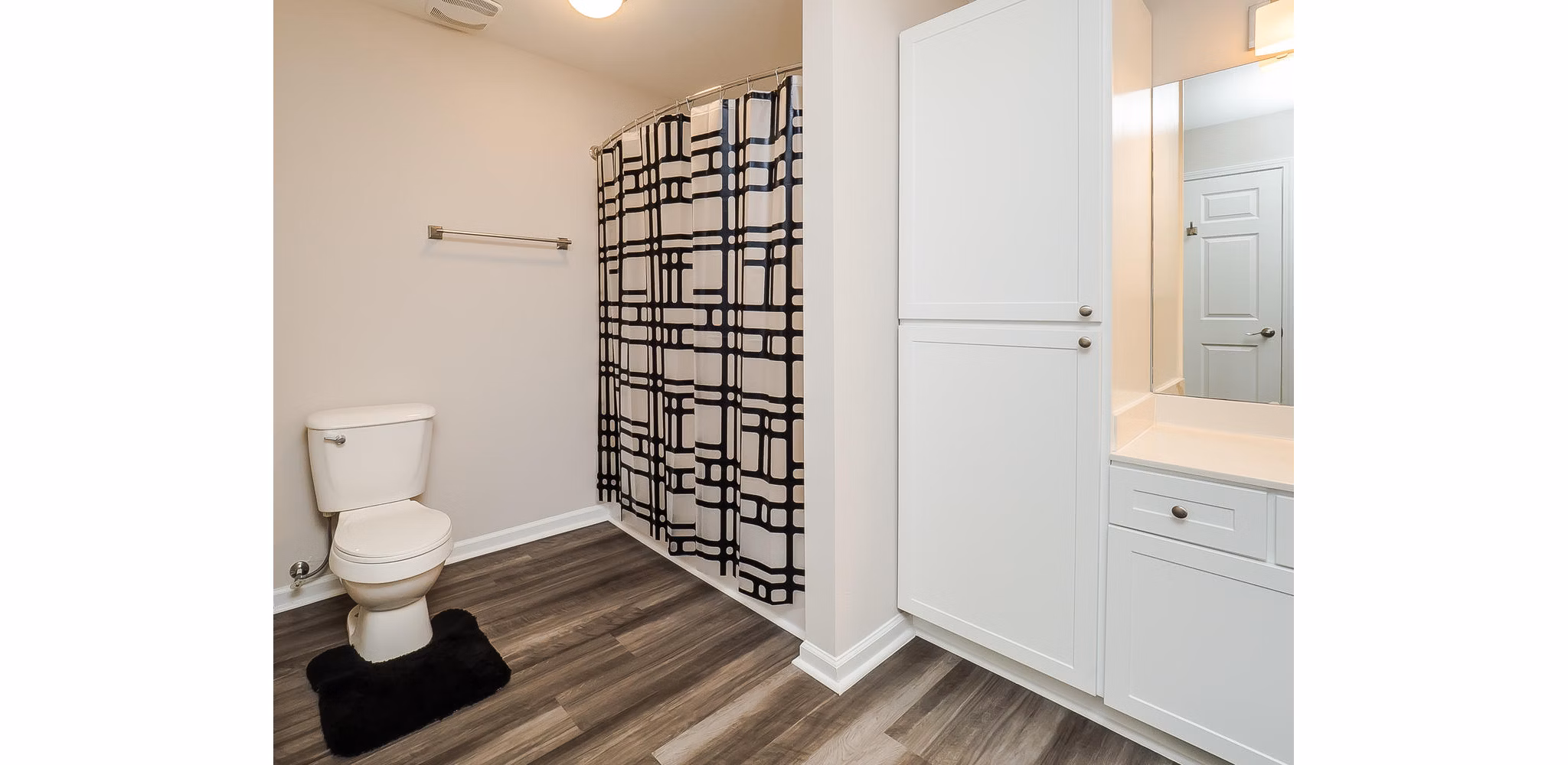 Bathroom with modern fixtures and large mirror at Patriots Pointe Apartments, a Greystar luxury apartment community