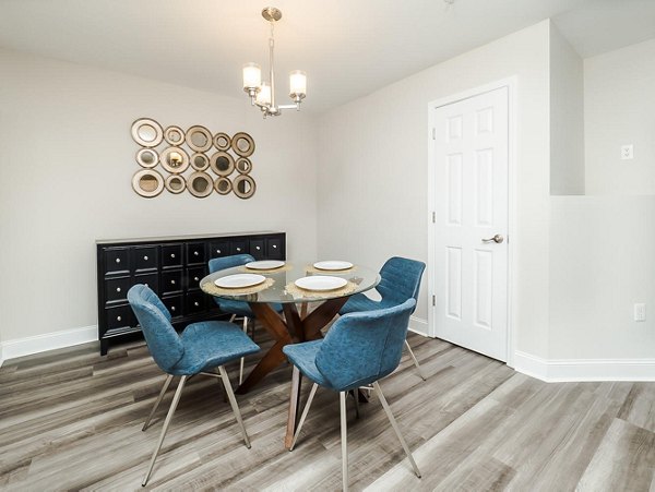 Dining area with contemporary furnishings at Patriots Pointe Apartments, offering modern luxury living spaces in a Greystar community