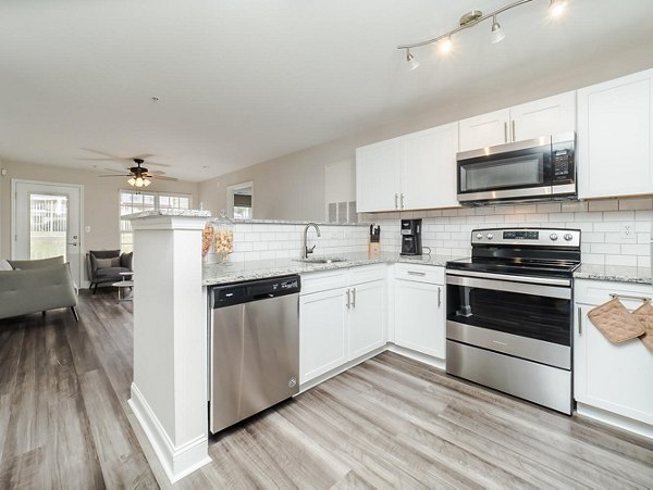 Modern kitchen with stainless steel appliances at Patriots Pointe Apartments