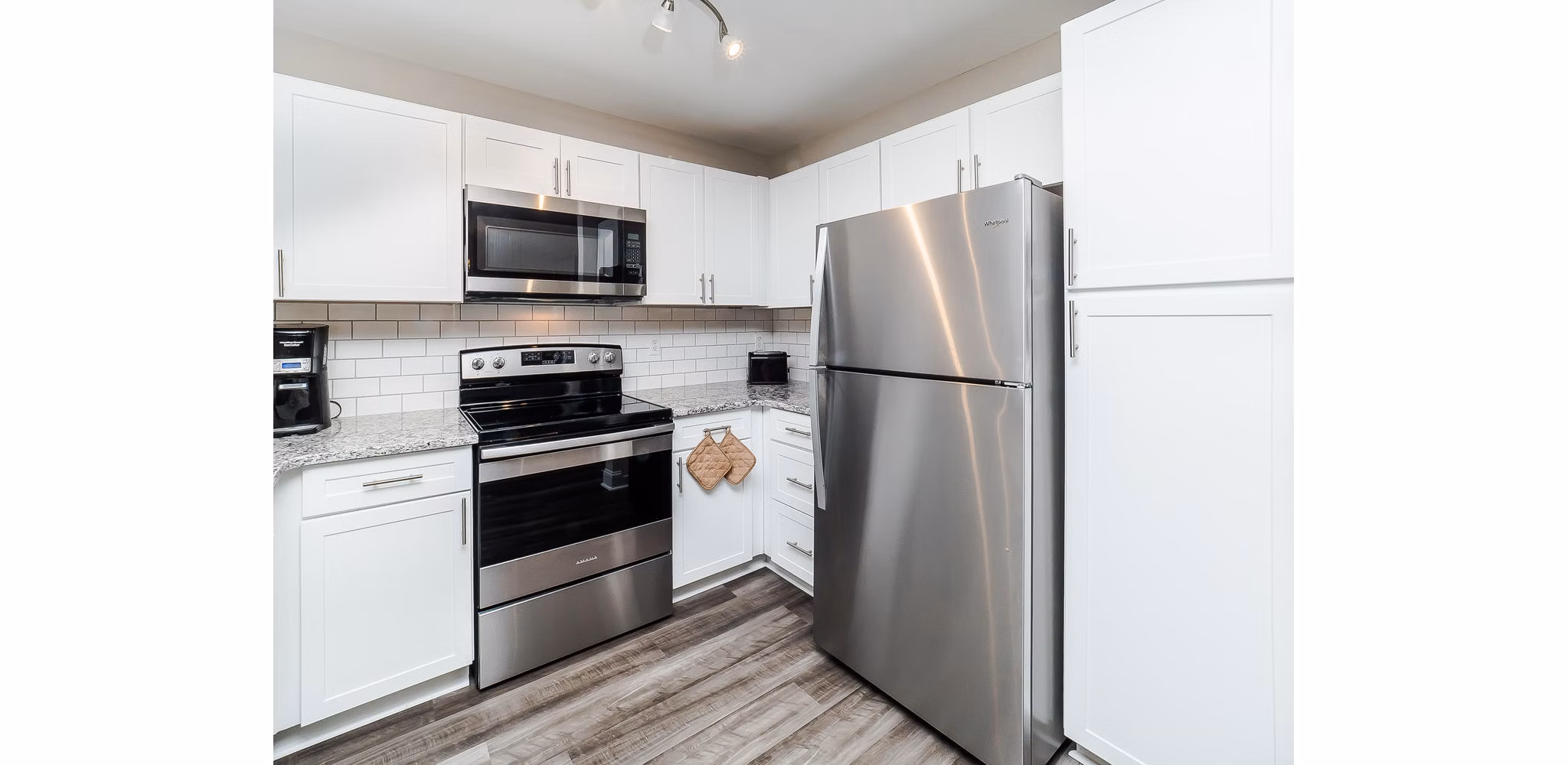 Modern kitchen with stainless steel appliances at Patriots Pointe Apartments