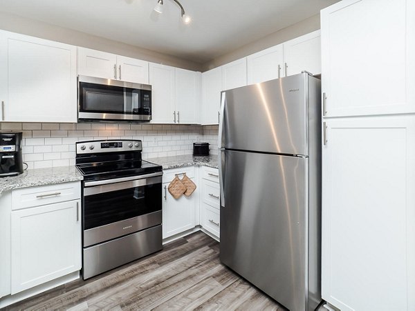 Modern kitchen with stainless steel appliances at Patriots Pointe Apartments