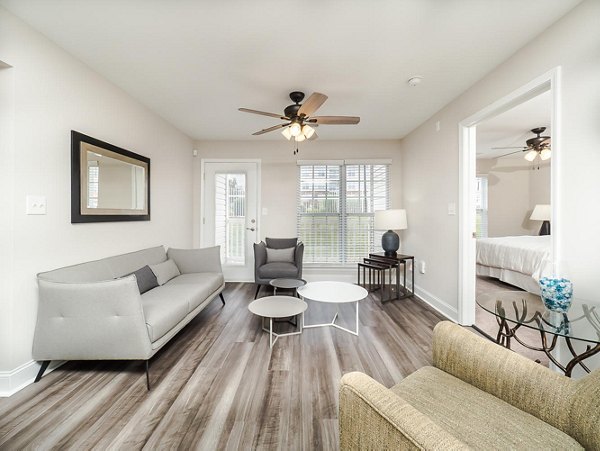 Cozy living room with stylish decor at Patriots Pointe Apartments, showcasing elegant furnishings and natural light ideal for relaxation and entertaining