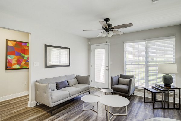 Spacious living room with modern decor and natural light at Patriots Pointe Apartments