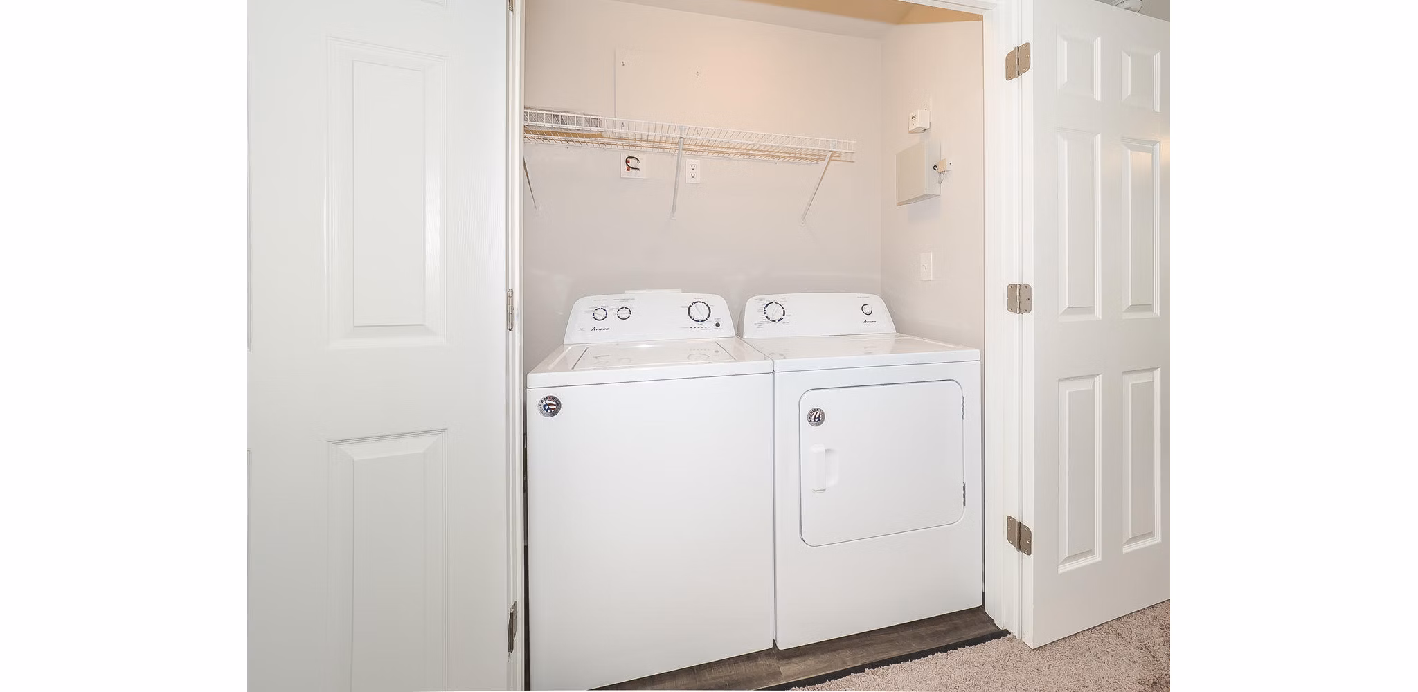 Laundry room with modern appliances in Patriots Pointe Apartments, a Greystar luxury community