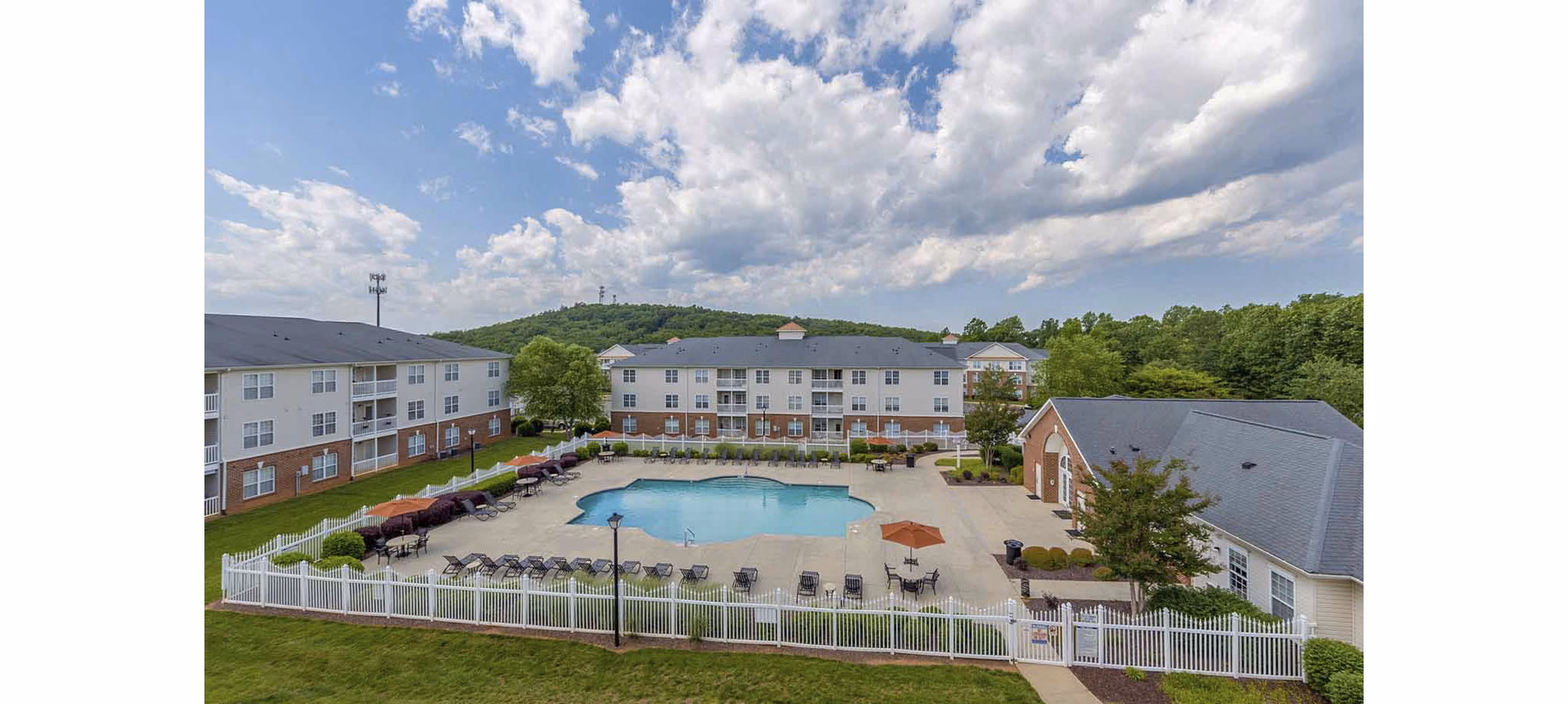 Sleek outdoor pool area with lounge chairs at Patriots Pointe Apartments, enhancing luxury living experience for residents