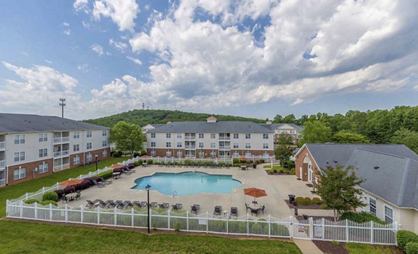 Sleek outdoor pool area with lounge chairs at Patriots Pointe Apartments, enhancing luxury living experience for residents