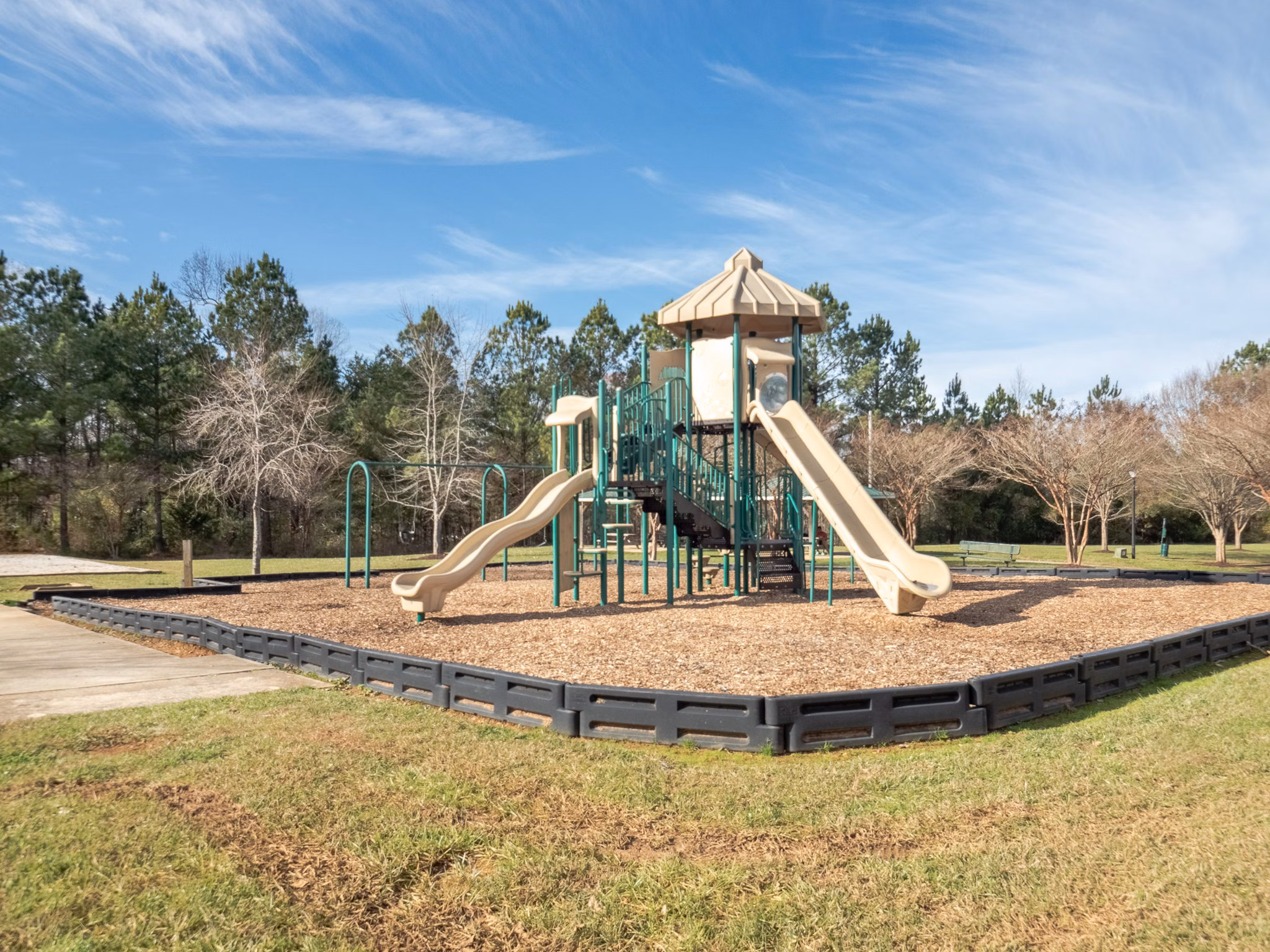 Colorful playground with slides and swings at Patriots Pointe Apartments, perfect for family-friendly living