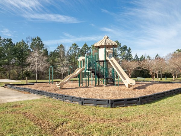 Colorful playground with slides and swings at Patriots Pointe Apartments, perfect for family-friendly living