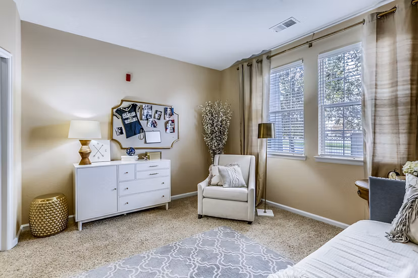 Elegant bedroom with contemporary design and large windows at Waterford Lone Tree Apartments
