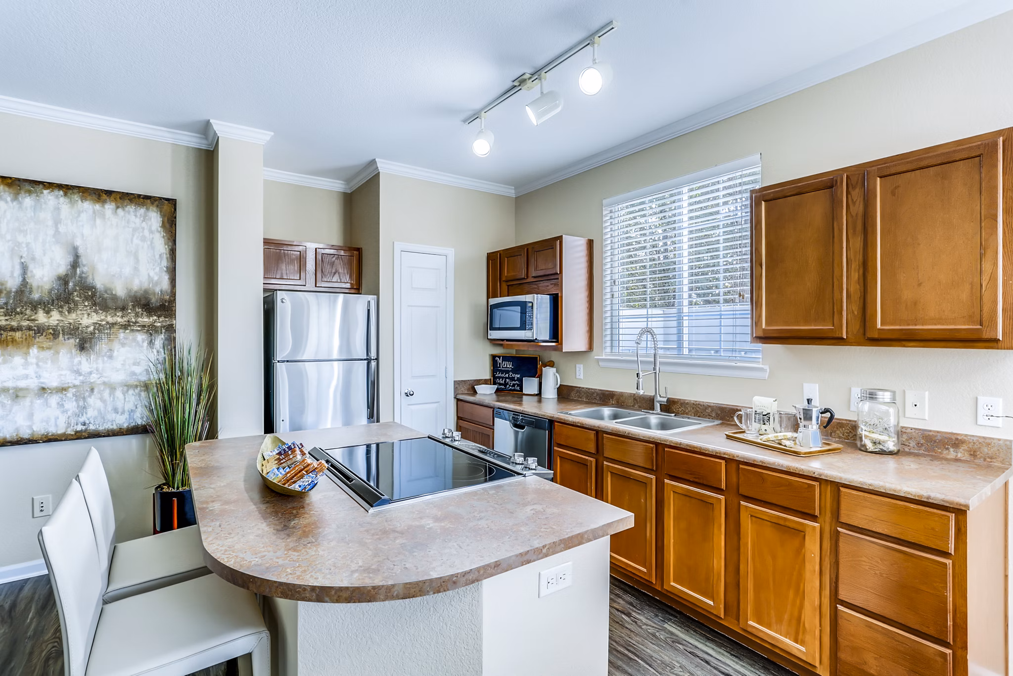 Kitchen featuring modern appliances and granite countertops at Waterford Lone Tree Apartments