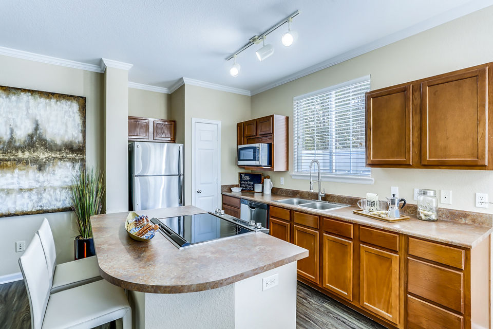 Kitchen featuring modern appliances and granite countertops at Waterford Lone Tree Apartments