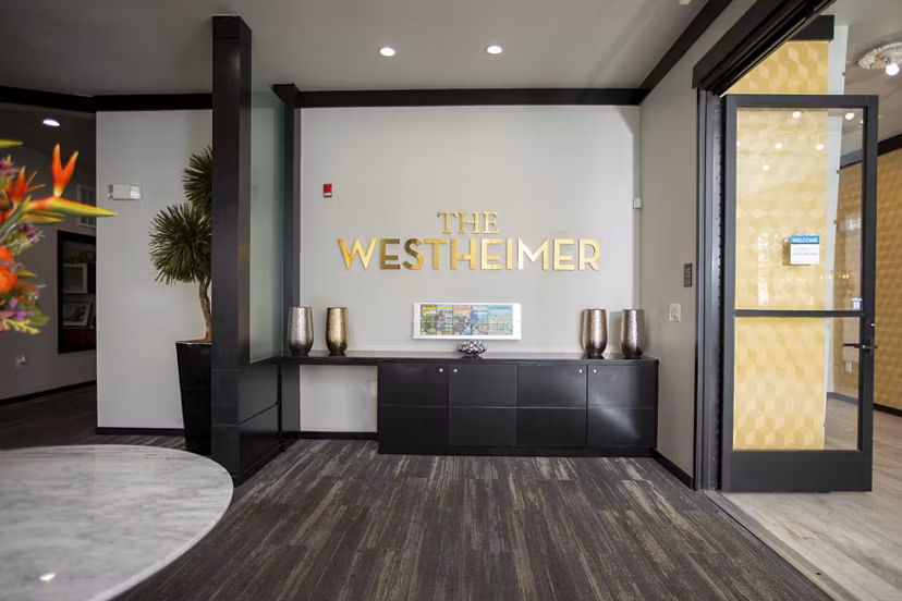 The Westheimer Apartments: Modern clubhouse featuring stylish lounge areas and vibrant decor, perfect for social gatherings and events