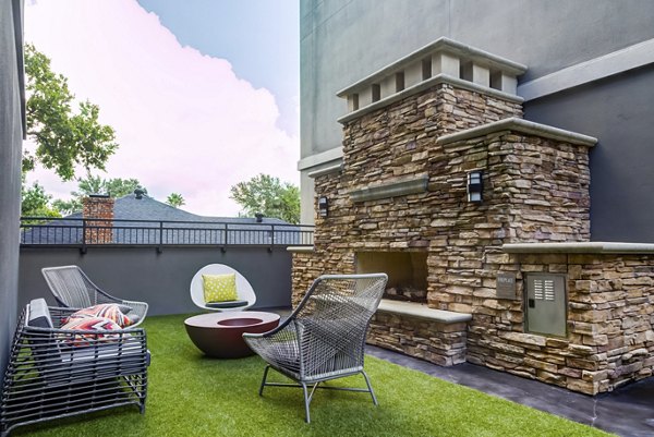 Chic outdoor patio with seating area at The Westheimer Apartments, ideal for relaxation and social gatherings