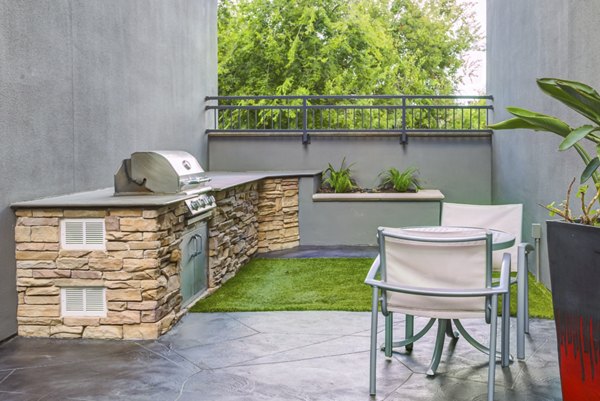 Modern grill area at The Westheimer Apartments featuring sleek design and outdoor seating for luxury outdoor living