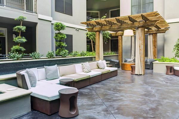 Patio at The Westheimer Apartments featuring modern outdoor seating and lush landscaping