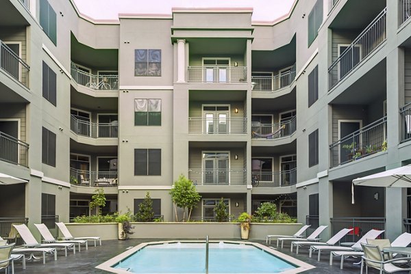 Contemporary swimming pool at The Westheimer Apartments with lounge seating in Houston