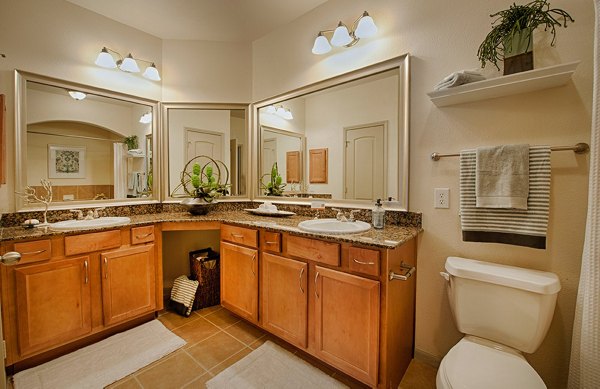 Luxurious bathroom featuring marble countertops at Monaco at Main Apartments